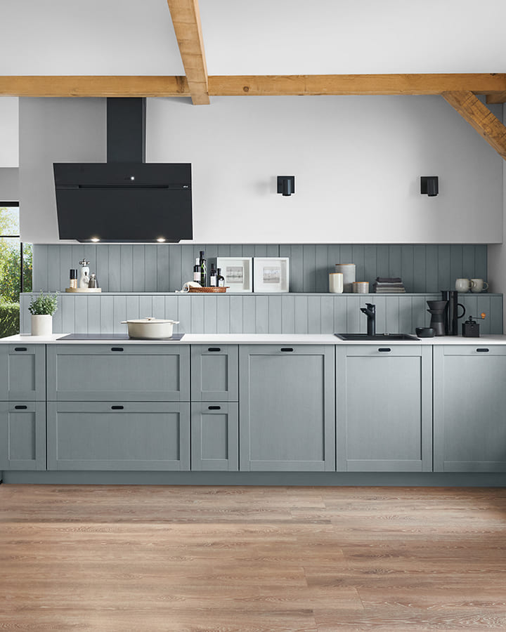 Rangée de façades à cadre bleu-gris sous une poutre apparente, lambris assorti et hotte noire inclinée